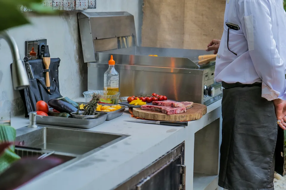 Steak, vegetables and herbs ready on the villa grill