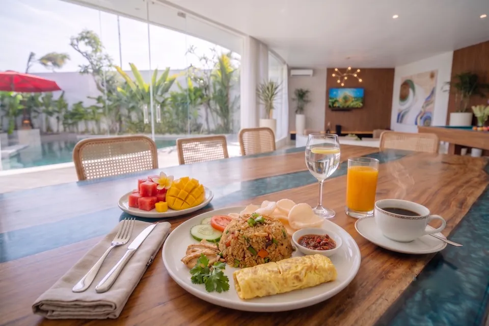 Indonesian breakfast: chicken fried rice, a rolled omelette and sambal, with fresh fruit, orange juice and coffee