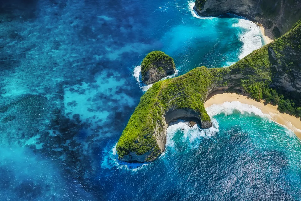 Aerial view of Kelingking Beach on Nusa Penida, its headland curving into a turquoise sea