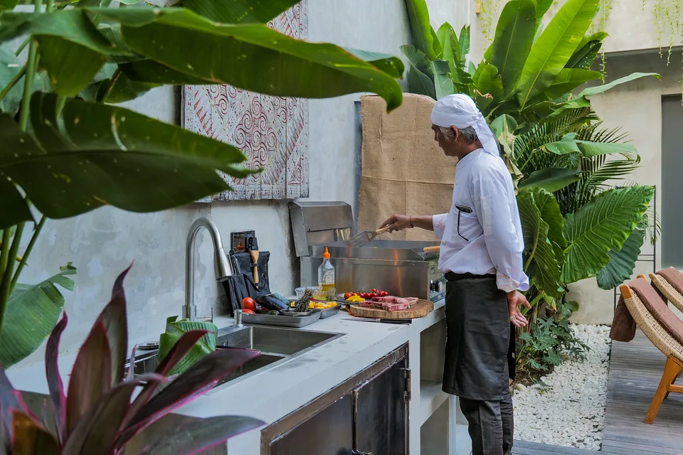 Our private chef grilling in the villa’s outdoor kitchen