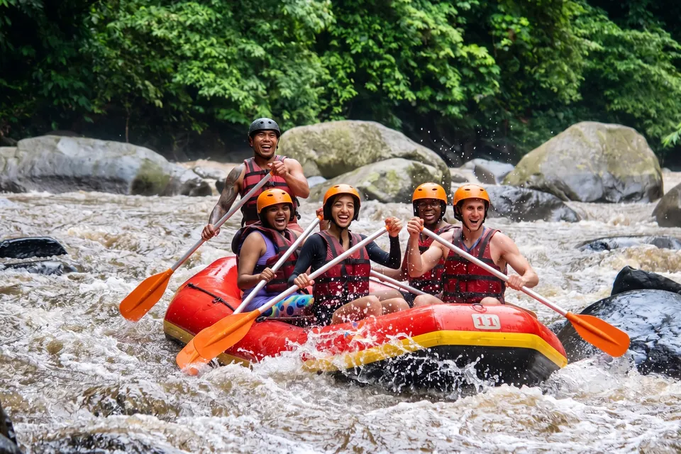 A group in helmets and life jackets paddling a raft through river rapids