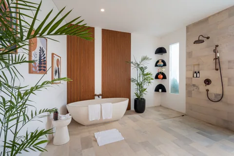 Villa Soluna's bright bathroom with a bath and walk-in shower